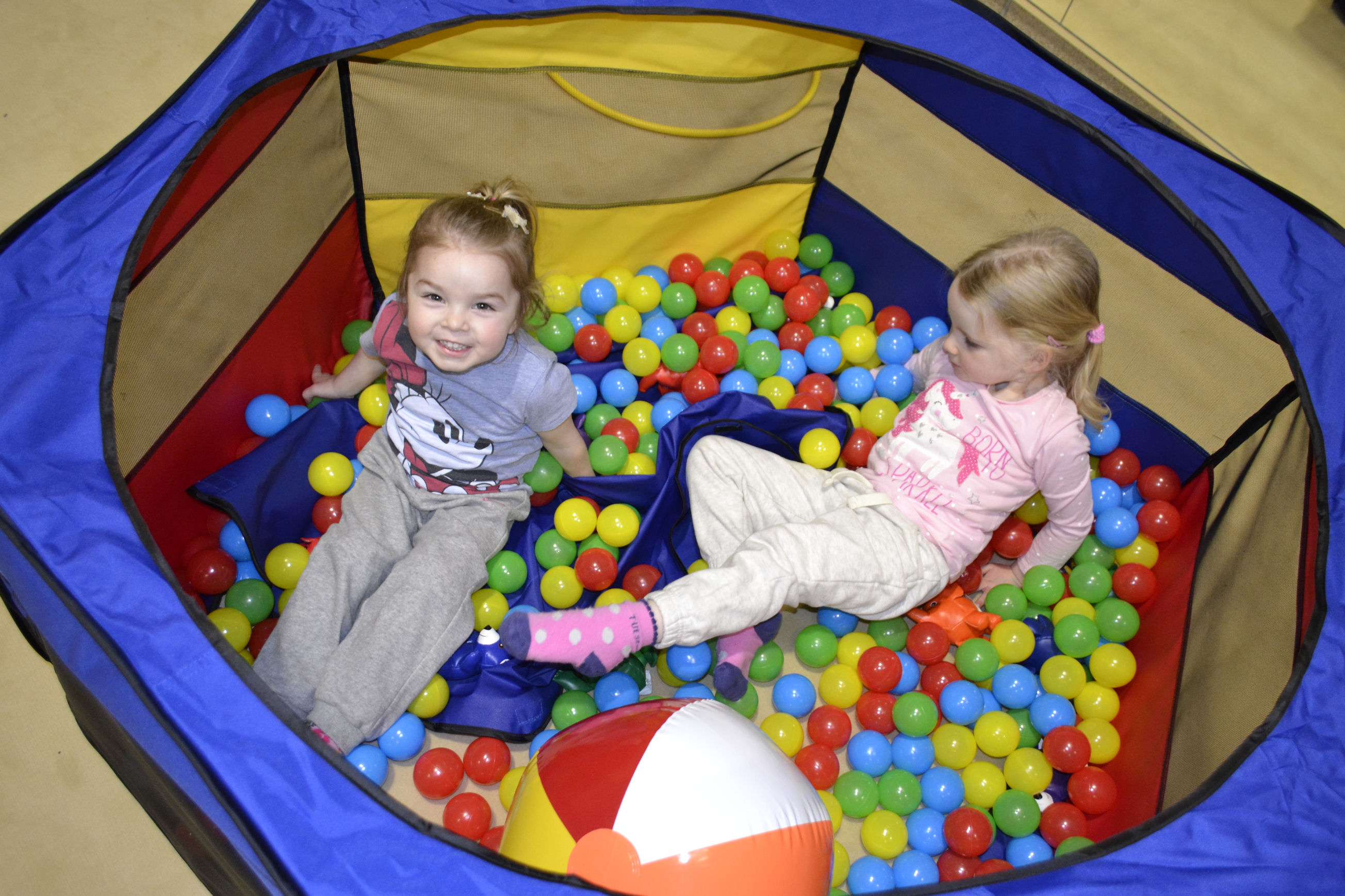 image of Gymnastics - 2 girls in a ball pit