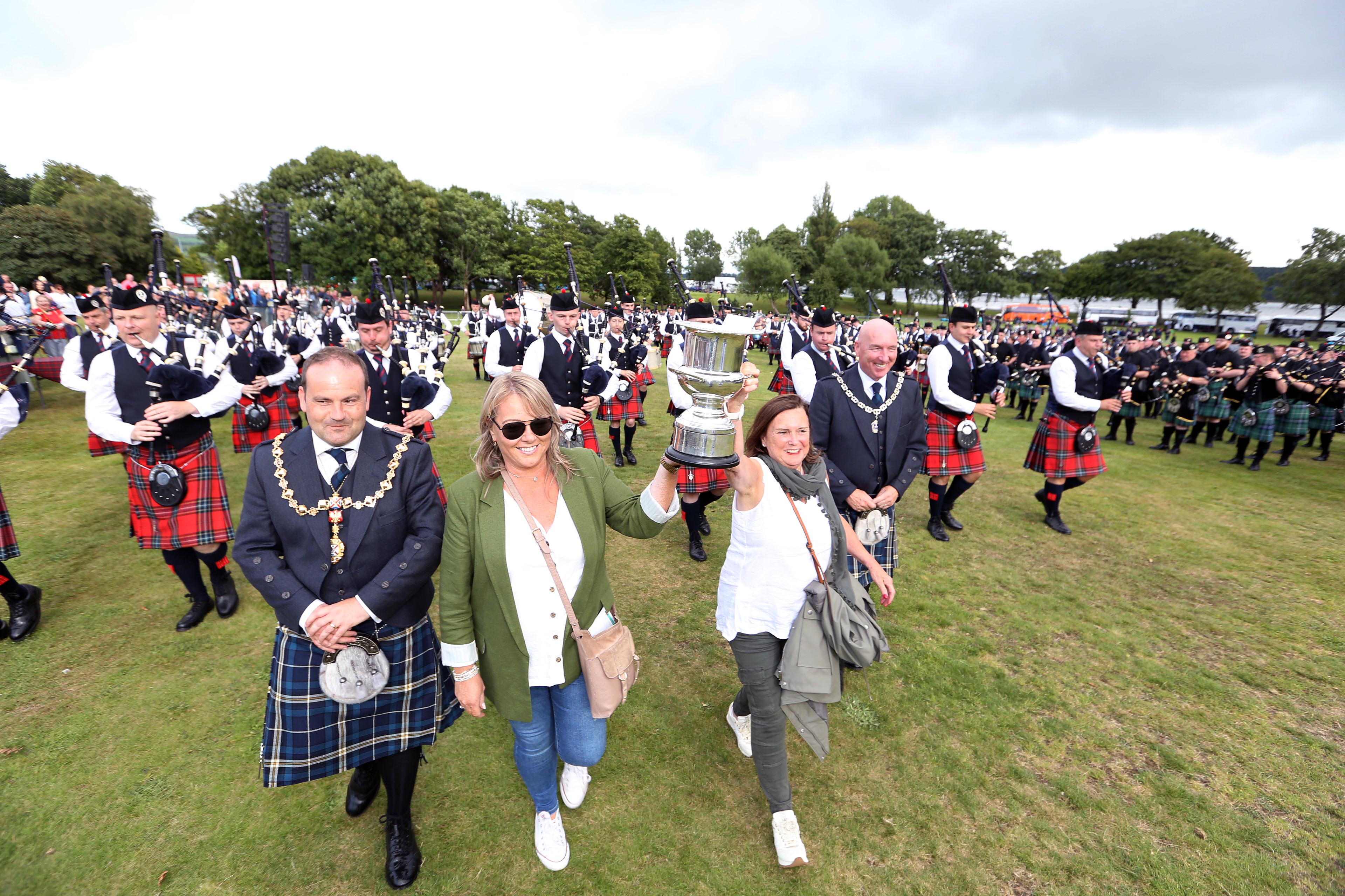 Provost walking in front of a Pipe Band